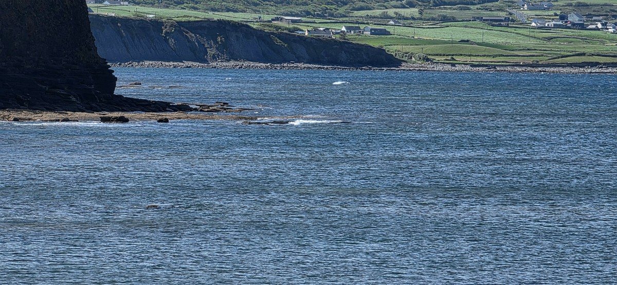 tiny unsurfable wave breaking on the reefs at high tide